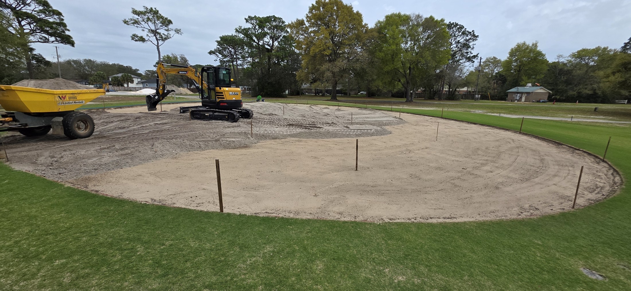 Excavator working on a golf feature under construction