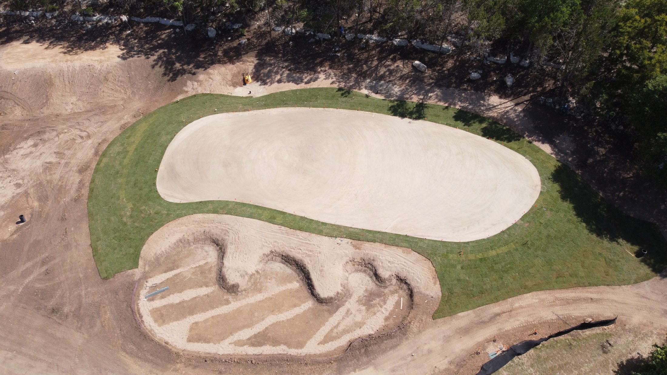 Aerial view of bunker construction beside a green at Spanish Oaks Golf Club