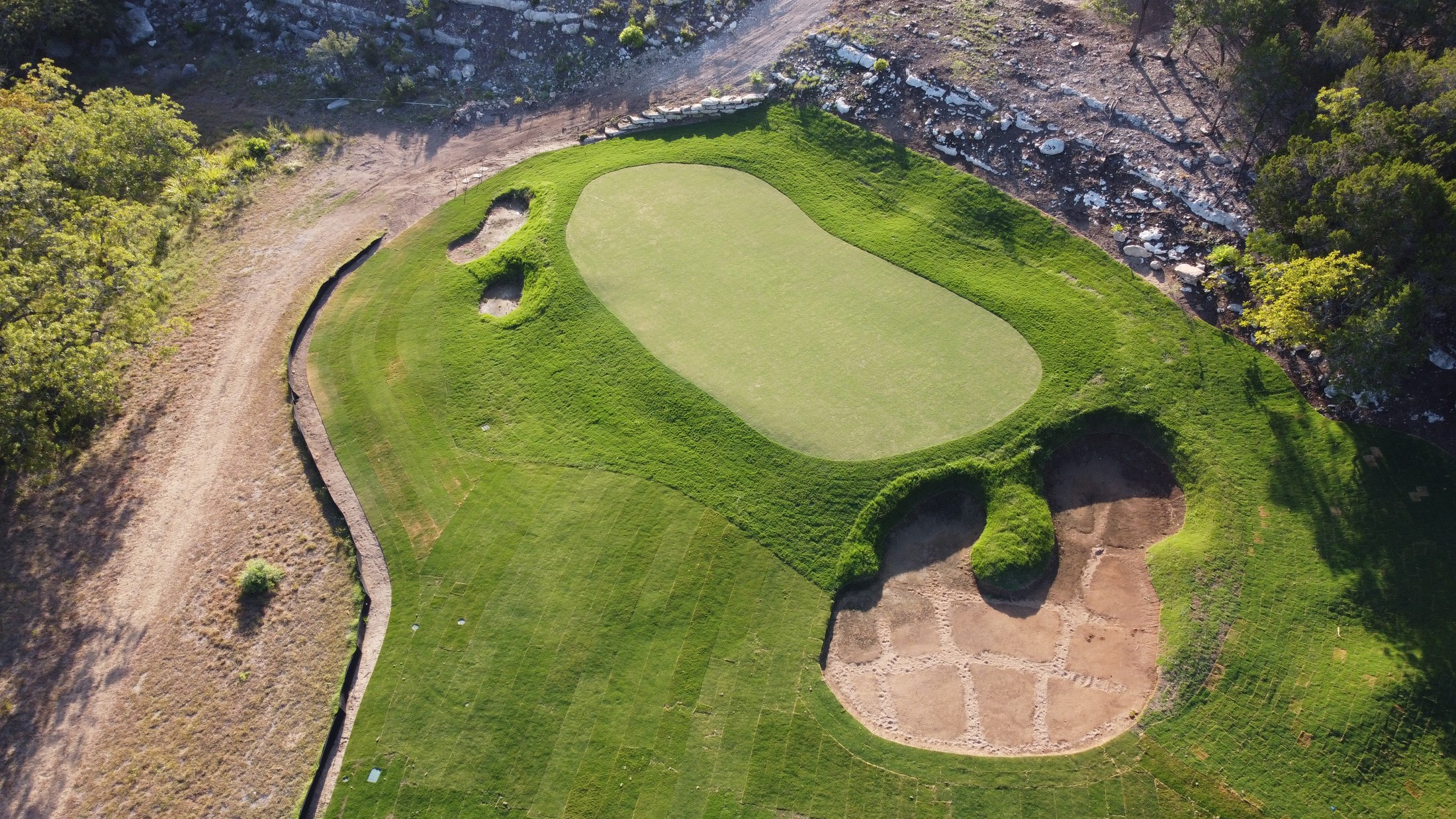 Overhead view of a finished green and bunkers at Spanish Oaks Golf Club